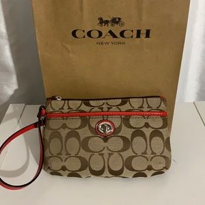 Coach wristlet with red patent leather trim